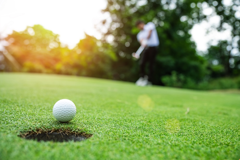 Golf ball on green at sunet
