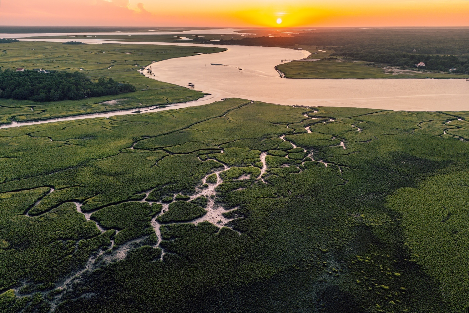 The Sun sets over the salt mash inside Horseshoe Creek flowing into Bohicket Cree, Seabrook Island SC
